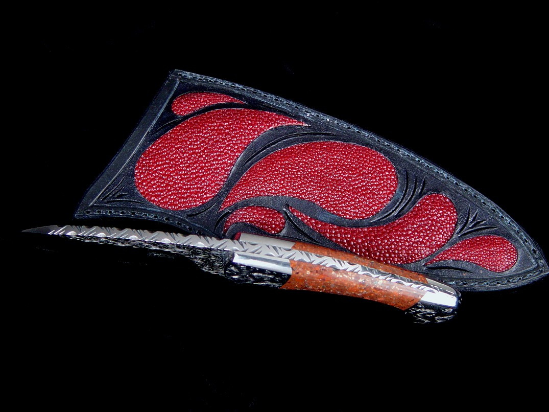 "Ocate" fine handmade custom skinning, field dressing knife, obverse side view in engraved 440C high chromium stainless steel blade, 304 stainless steel bolsters, copper ore gemstone handle, red Stingray skin inlaid in hand-carved leather sheath