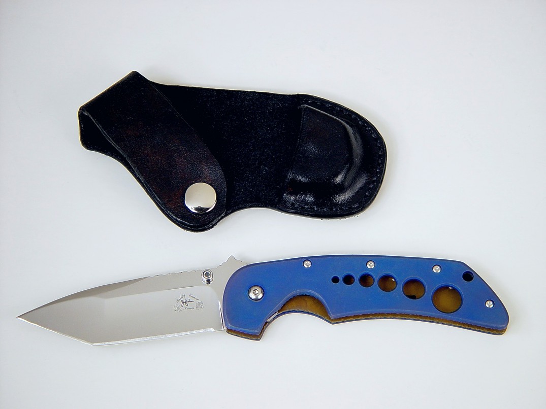 "Stratos" liner lock folding knife, obverse side view: 440C stainless steel blade, anodized 6AL4V titanium liners, leather, nickel plated steel sheath