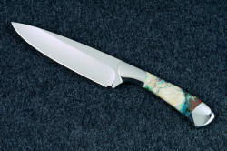 Smooth hollow ground edge and deep heel of "Cygnus" Custom handmade chef's knife in T3 cryogenically treated 440C high chromium stainless steel blade, 304 stainless steel bolsters, Cuprite mosaic gemstone handle, hand-tooled leather sheath