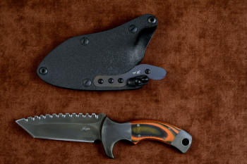 "Krag" tactical, counterterrorism, crossover knife, obverse side view in T4 cryogenically treated 440C high chromium martensitic stainless steel blade, 304 stainless steel bolsters, Orange and Black  G10 fiberglass/epoxy composite handle, hybrid tension tab-locking sheath in kydex, anodized aluminum, black oxide stainless steel and anodized titanium