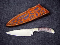 "La Cocina" chef's knife, obverse side view in 440C high chromium stainless steel blade, 304 stainless steel bolsters, Lace Amethyst gemstone handle, hand-carved and tooled leather sheath