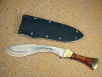 "Nasmyth-Marius" handmade custom khukri, obverse side view in satin finished 440C high chromium stainless steel blade, naval brass bolsters and pins, Honduras Rosewood hardwood handle, kydex, aluminum, blued steel sheath