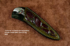 "Lacerta" sheathed view in deep cryogenically treated O1 tungsten-vanadium tool steel blade, hot blued, 304 stainless steel bolsters, Eudialite gemstone handle, sheath of hand-carved leather inlaid with Ostrich leg skin